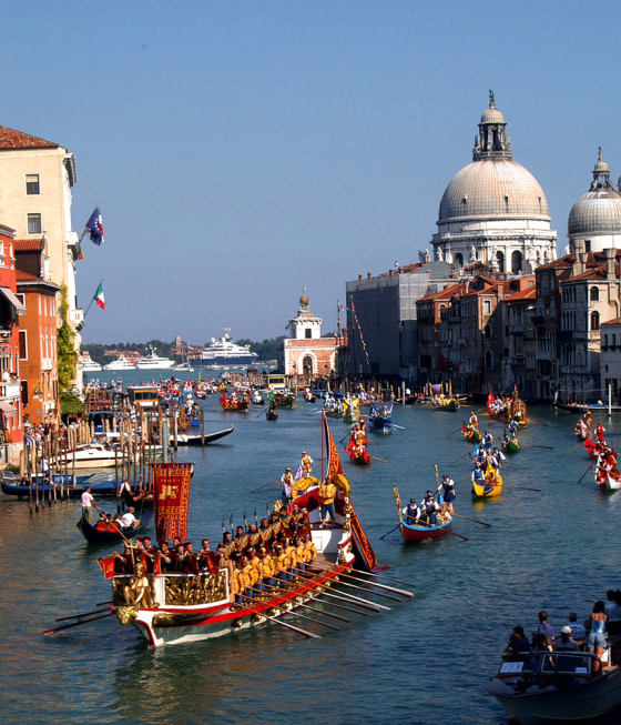 The Bucintoro, the barge of Venice's ruler, the Doge, leads a parade of historical venetian boats as it sails along the Grand Canal during the Historical Regatta, in Venice, Italy.