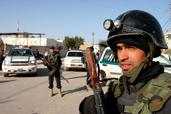 Iraqi soldiers guard central Karbala, Iraq, on Monday after gunmen stormed provincial headquarters in an attack that left five U.S. soldiers dead.