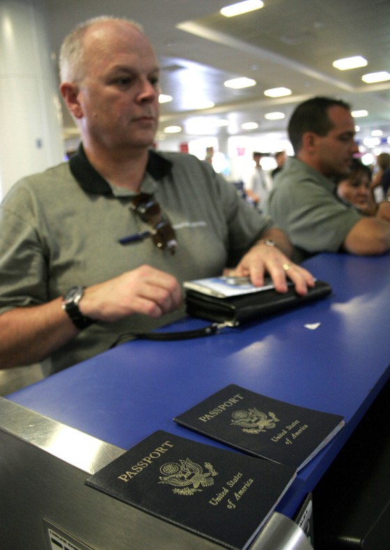 Bill Moore, 56, from Denver, Colo., checks in at an airline counter in the resort city of Cancun, Mexico, on the day new American regulations designed to enhance security took effect.