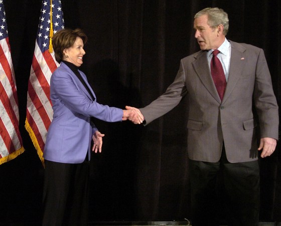 US President George W. Bush (R) shakes h