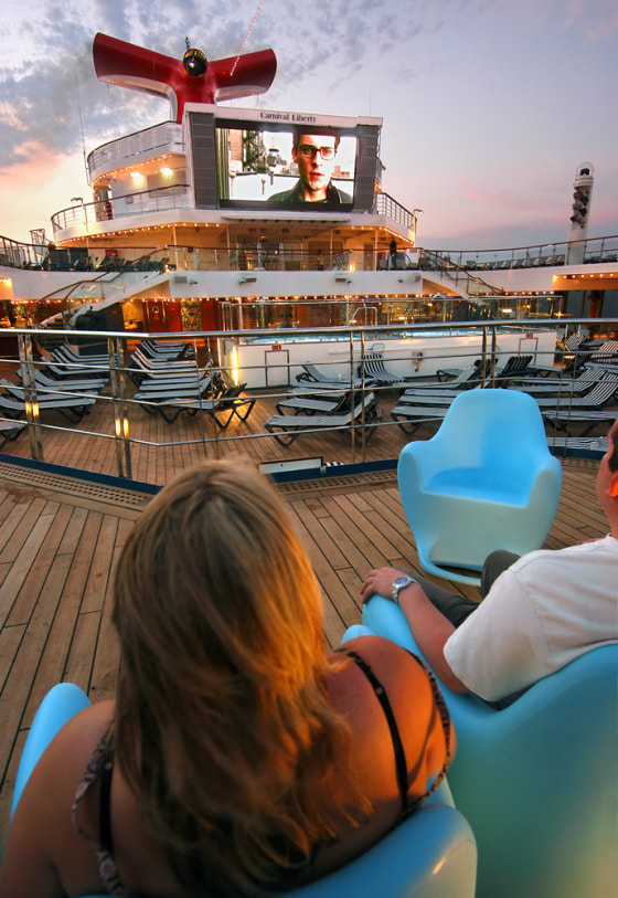 Guests on the Carnival Liberty enjoy a movie on the ship's outdoor 264-square-foot, light emitting diode video screen.