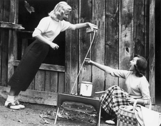 This 1957 publicity photo shows milk seemingly being poured at an angle, demonstrating the "mystery" of The Wonder Spot in Lake Delton, Wis. 