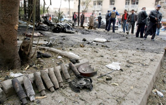 Artillery shells used to make a car bomb lay gathered by Iraqi police near the scene of an explosion in central Baghdad, Iraq, on Saturday.