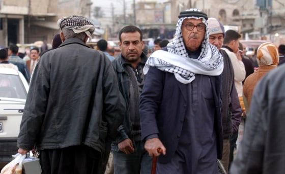 People walk down a street Sunday in downtown Kirkuk, north of Baghdad, Iraq. Even as the world focuses on Baghdad's security, a series of bombings here may be the long-feared start of a second deadly war in Iraq, this one between Kurds and Arabs.