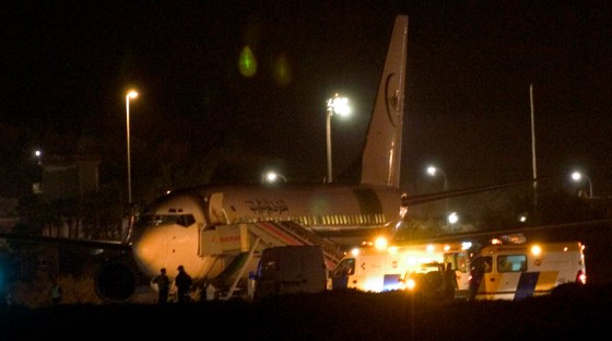 A hijacked Air Mauritania Boeing 737 plane is surrounded by Spanish security forces after landing in Las Palmas in Spain's Canary Islands