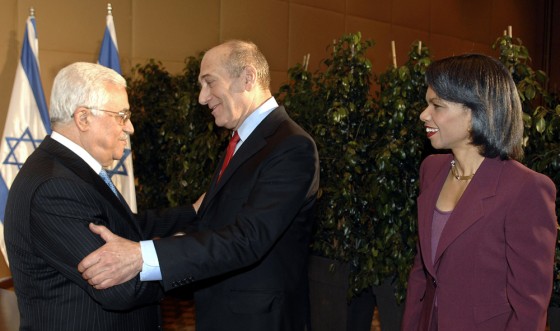 Secretary of State Condoleezza Rice looks on as Palestinian Authority President Mahmoud Abbas, left, and Israeli Prime Minister Ehud Olmert greet each other Monday at a meeting in Jerusalem.
