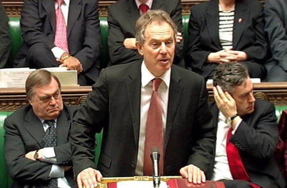 British Prime Minister Tony Blair, center, addresses the House of Commons Wednesday to announce the first large-scale British troop withdrawal from Iraq. 