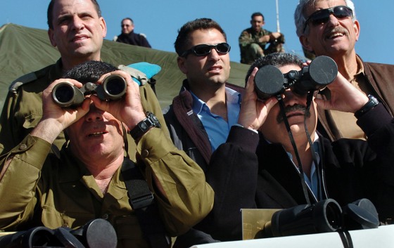 Israeli Defense Minister Amir Peretz, right, gazes at a military drill through binoculars Wednesday, apparently without realizing the lens caps were left on. The army's chief of staff, Lt. Gen. Gabi Ashkenazi is at left.