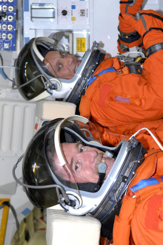 Atlantis astronauts James Reilly and Danny Olivas sit in a prone position on the shuttle's middeck, during a simulated launch countdown at Launch Pad 39A at NASA's Kennedy Space Center on Friday.