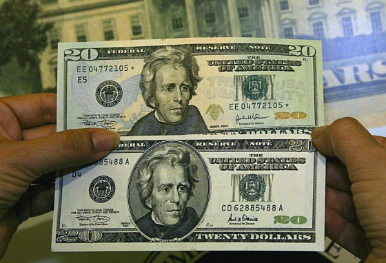 US Treasurer Rosario Marnin displayed the newly redesigned $20 note (top) against the old $20 bill, May, 2002 in Washington, DC.
