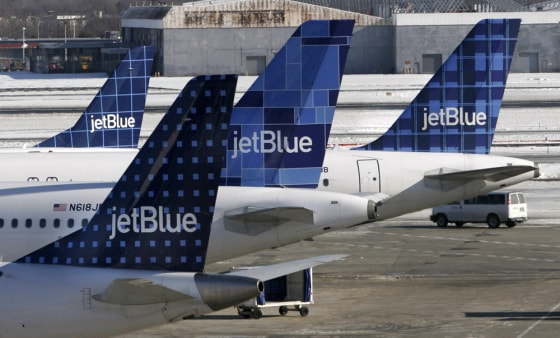 JetBlue planes wait at terminal gates at JFK Airport in New York on Feb. 16. JetBlue travelers continued to experience delays and cancellations as the airline struggled for a third day to recover from an operational meltdown.