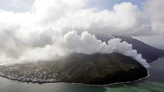 Steam rises where lava flows into the sea from a hillside as viewed by a Guardia di Finanza helicopter flying over the volcanic Italian island of Stromboli