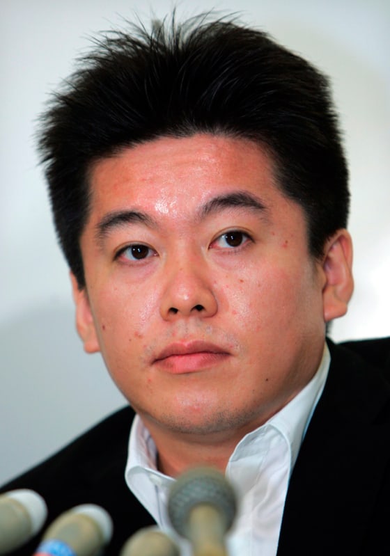 File photo of Takafumi listening to a journalist at a news conference in Tokyo