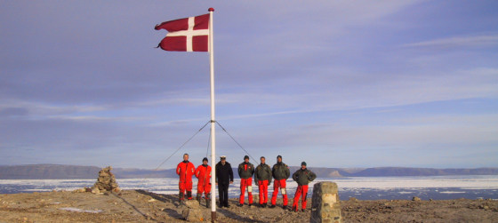 The crew of the Danish warship Vedderen&nbsp;raise Denmark's flag on the disputed&nbsp;Hans Island off Greenland in this Aug. 13, 2002, file photo.