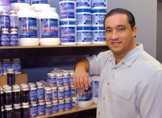 Jared R. Wheat, president and CEO of Hi-Tech Pharmaceuticals, poses in front of a display of the company's products in a Dec. 22, 2005, file photo.