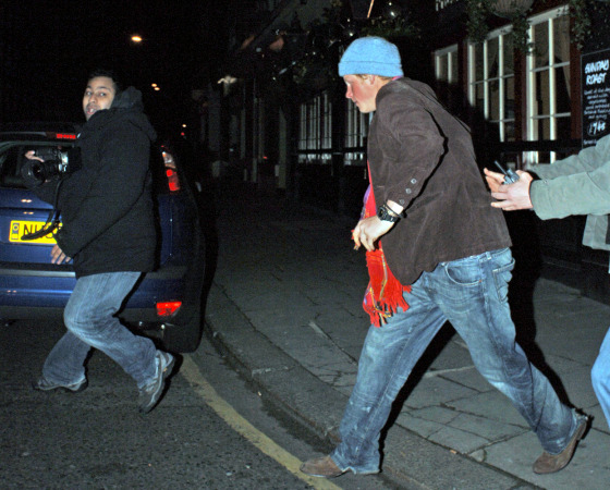 Prince Harry, pictured outside the Boujis nightclub in London, heads to a waiting car Saturday night.