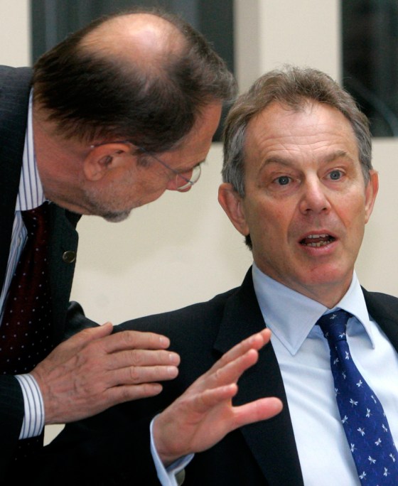 British Prime Minister Blair gestures speaks with EU foreign policy chief Solana during a working lunch at the EU summit in Berlin