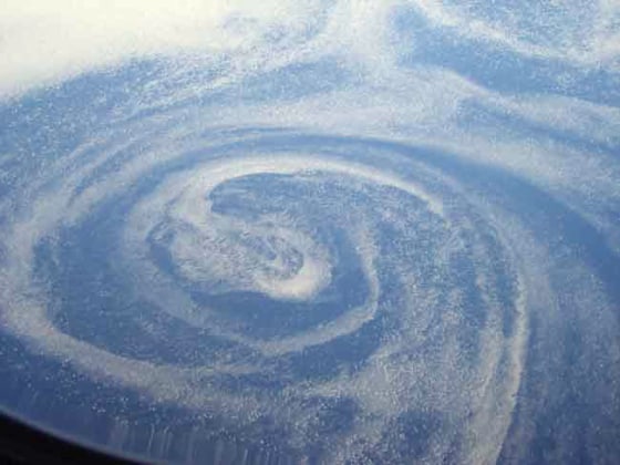 An oceanic eddy or vortex over the marginal ice zone near Greenland. The oceanic circulation can be seen in the movement of small ice floes on the surface.