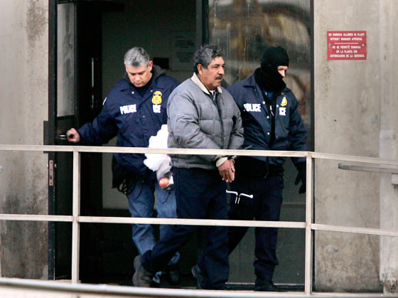 An unidentified Swift & Co. employee is escorted out of the Greeley Lamb Plant by Immigration and Custom Enforcement agents in Greeley, Colorado