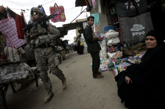A U.S. Army soldier from B Company, 1st Battalion, 23rd Infantry Regiment patrols an open marketplace in Baghdad's Shiite enclave of Sadr City, Iraq.