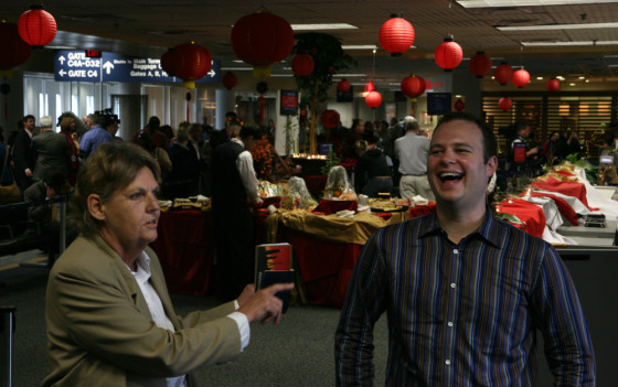 Andrew Gibbons, right, talks to fellow flight enthusiast, Fran Jelley of Australia, at Dulles International Airport before they both take United's inaugural flight to Beijing.