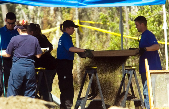 Investigators with the Florida Department of Law Enforcement and the Fort Myers Police Department sift through dirt Monday at the site where eight skeletons were found.