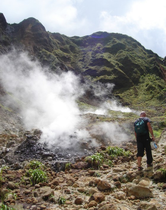 The Valley of Desolation on Dominica is an eerie, treeless swath of volcanic devastation striped black and orange with mineral deposits and swirling with mist and steam.
