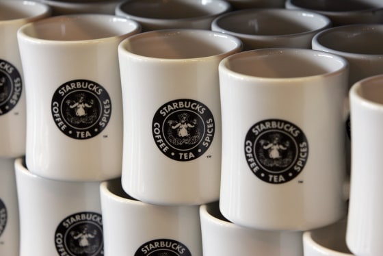 The coffee giant has grown since its humble days of the original logo — here emblazoned on mugs at the original Starbucks at the Pike Place Market in Seattle.