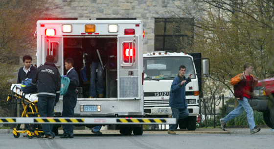Virginia Tech students run from Norris Hall as an ambulance arrives on the scene in Blacksburg, Va., on April 16. That day's shooting — the worst of its kind in U.S. history — prompted the kinds of questions that have followed past massacres, namely, what is it about modern-day America that provokes such random violence?