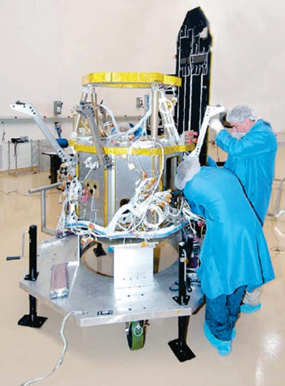 Technicians work on the Near Field Infrared Experiment, or NFIRE, during the satellite's construction. NFIRE is due for launch early Monday atop a Minotaur rocket.