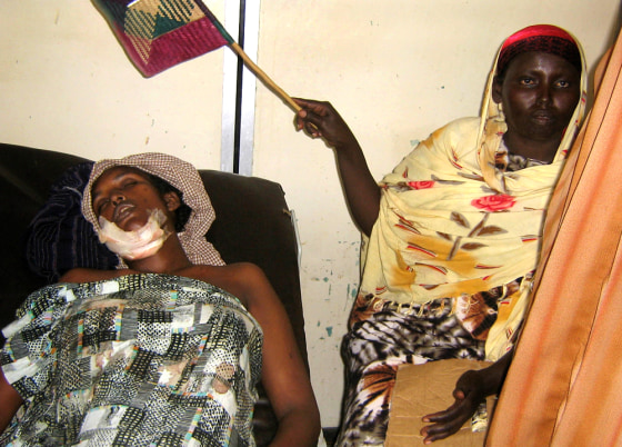 A woman uses a fan to cool a wounded friend Sunday at Medina Hospital in Mogadishu, Somalia. Heavy fighting persisted in the Somali capital as Islamic insurgents, based in residential areas, battled Ethiopian troops on streets in the city's southern and northern districts.