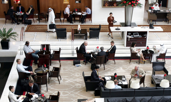 The lobby of the Emirates Towers hotel in Dubai, United Arab Emirates, is crowded with business people holding meetings. Sustained high oil prices have left state-owned investment companies in the Gulf with a lot of buying power.