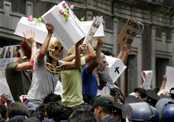 Anti-abortion activists face off with riot police separating them from pro-choice activists near Mexico City's local legislature