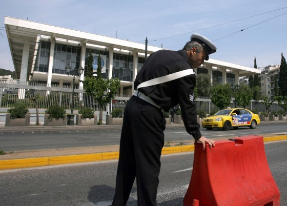 A police officer stands guard outside the U.S. Embassy in central Athens on Wednesday.
