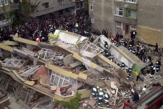 Rescuers search through an apartment blo