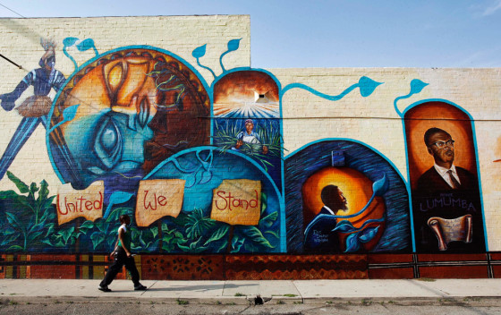 A woman walks in front of a large mural in the Leimert Park Village section of South Central Los Angeles on April 6. The neighborhood is filled wih rows of Afro-centric boutiques, cafes and soul food restaurants.