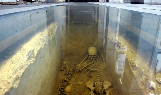 A skeleton is seen behind a glass at a 17th-century convent, home of Lisbon's Academy of Sciences in Lisbon, Portugal. Countless human bones believed to belong to victims of Lisbon's 1755 earthquake were found in a mass grave during restoration works at the academy.