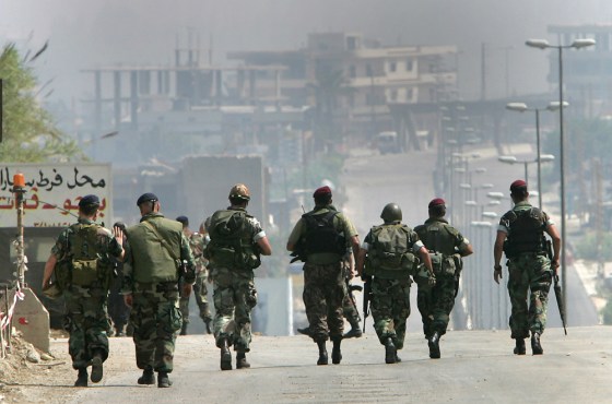 Lebanese army special forces walk to help other Lebanese troops fight militants on Sunday from the Fatah Islam group at Nahr-el-Bared Palestinian refugee camp near Tripoli.