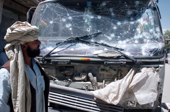 An Afghan man looks at a vehicle damaged