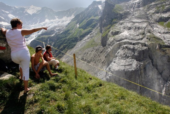 Hikers watch a slab of rock at Switzerland's Eiger Mountain on July 15, 2006. The slab, about the size of two Empire State buildings, finally broke off last year.