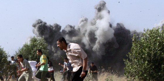Palestinians run following an Israeli ai