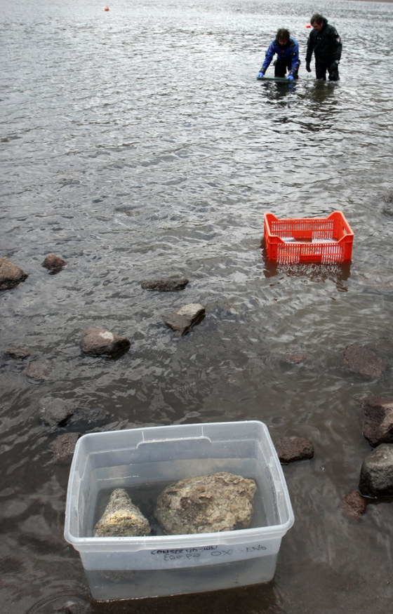 Archaeologist Roberto Junco, left, and diver Fernando Lozano return with items found in the Nevado de Toluca volcano in Mexico.
