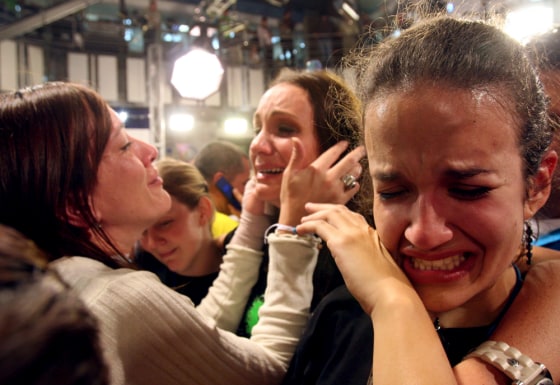 Employees of Radio Caracas Television cry as the channel's signal is cut in Caracas, Monday, May 28, after President Chavez decided not to renew the the opposition-aligned channel's broadcasting license.