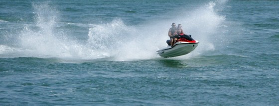 Riders on a personal watercraft roar across the water at the end of South Beach in Miami Beach, Fla. As the summer vacation season kicks off, tourist shouldn't forget this is also a a hurrincane-prone area.