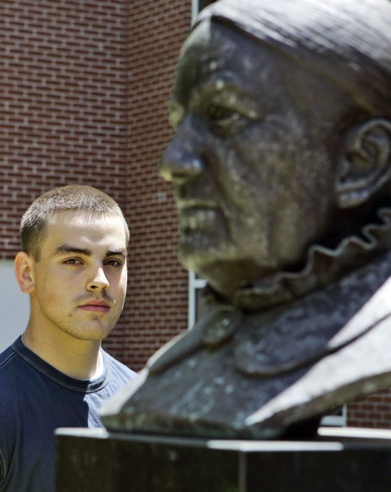 Michael Roberts poses with the bust of Benedict College founder Bathsmeba Benedict outside the administration building on May 9. Roberts is one of the few white students at the historically black college. 