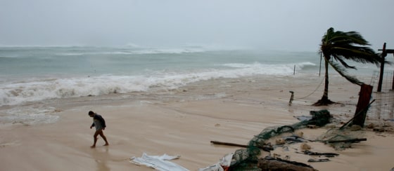 Summertime is a great time to visit the Caribbean, but is also right in the thick of hurricane season. In this 2005 file photo, a man walks along the beach as Hurricane Wilma approaches Playa del Carmen, Mexico.