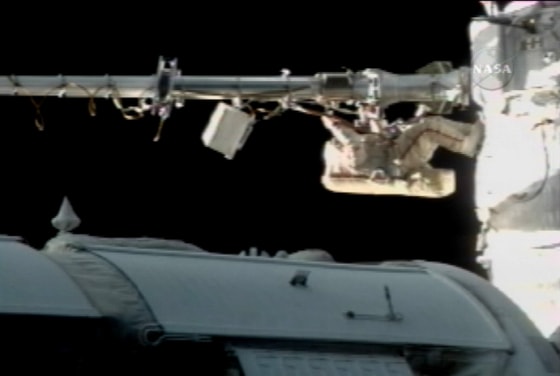 Russian cosmonaut Fyodor Yurchikhin seems to hang upside down as he operates a Strela crane on the international space station during Wednesday's spacewalk. In the microgravity of orbital flight, however, there's little difference between "upside down" and "right side up."