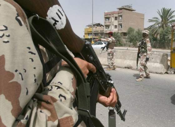 Iraqi soldiers man a checkpoint on a major road in the Sadr City neighborhood in Baghdad on Wednesday. Iraqi and U.S. forces conducted raids in the neighborhood in the early morning, apparently searching for five British men abducted Tuesday from a nearby building.