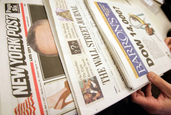 Rupert Murdoch's New York Post, left, is photographed with Dow Jones' The Wall Street Journal, center, and financial weekly Barron's.