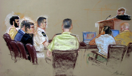 In this sketch cleared for release by U.S. military officials, detainee Omar Khadr, far left, sits flanked by three lawyers on Monday.